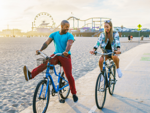 couple riding bikes near the beach